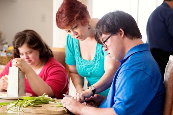 A Carer assisting people with cooking