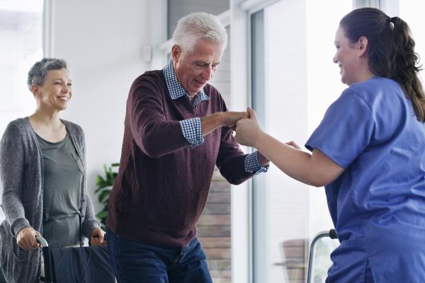 Nurse helping man stand