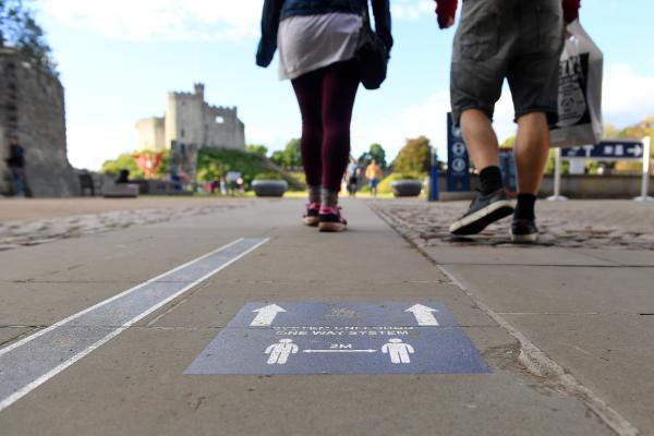 Signs on pavement relating to social distance