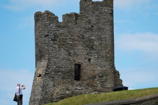 a man taking a picture of a castle