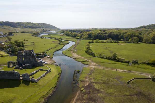 aerial view of a river and castle remains