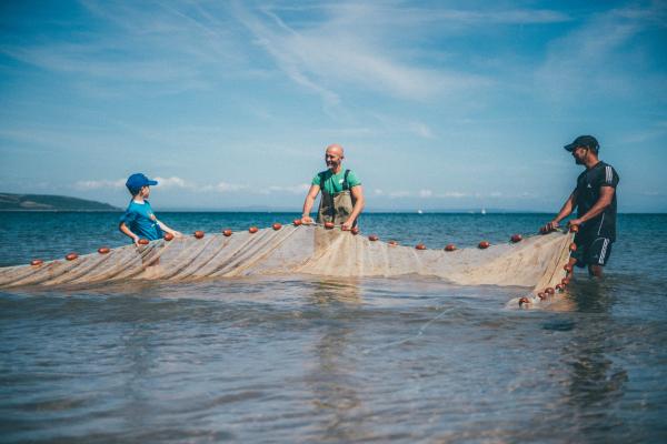 2 men and a child fishing in the sea