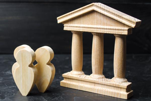 Three figurines outside governmental building