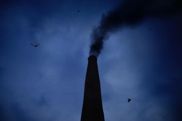 a smokestack releasing gases into the air