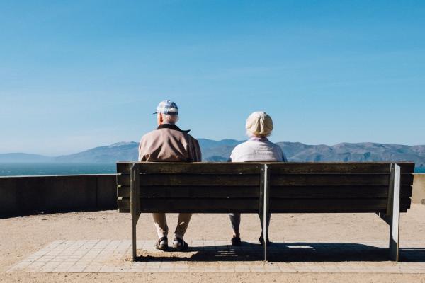 Elderly couple sat on a bench