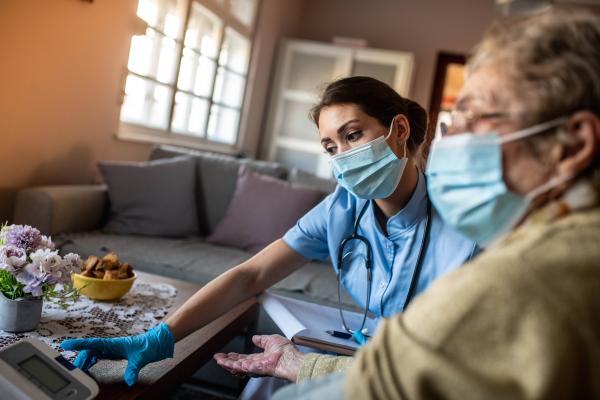 Care worker assisting woman