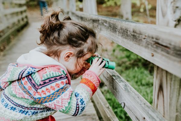 Child looking through binoculars