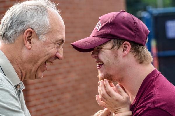 two men laughing in conversation