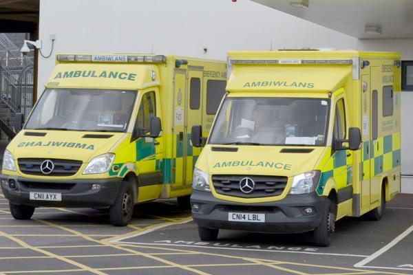 2 ambulances parked outside a hospital
